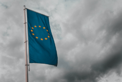 EU flag in front of a darkened sky