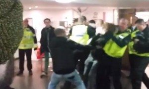 Video appearing to show a policeman with a student in a headlock