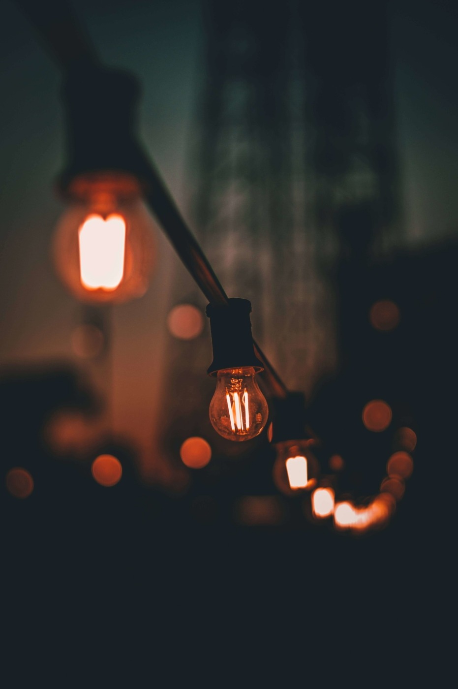 Image: A string of lightbulbs in a dark setting / Unsplash