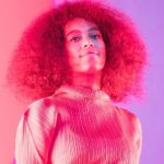 Solange on stage in a pink hue