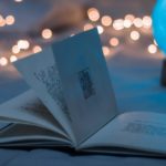 Small book open with fairy lights behind