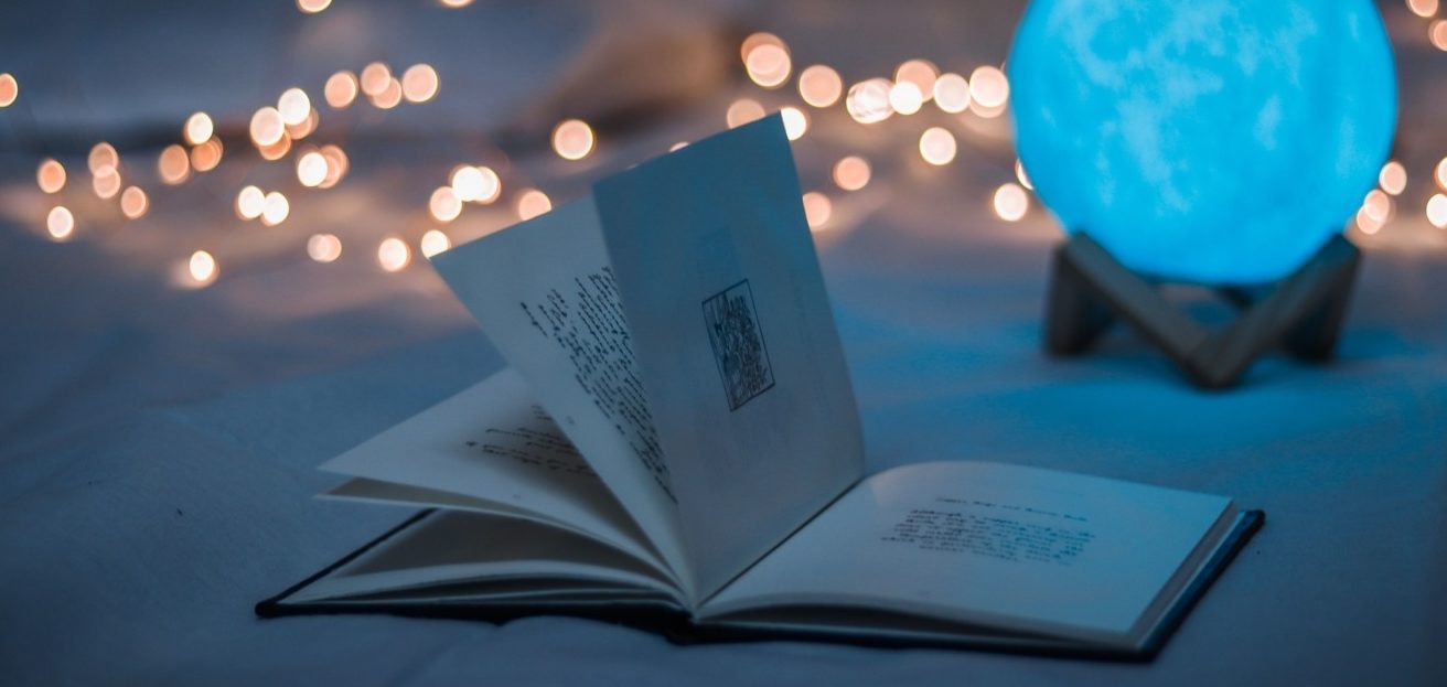 Small book open with fairy lights behind