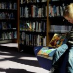 Small child sitting in a library