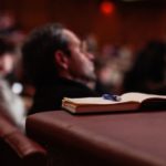 Open notebook in the audience of a theatre
