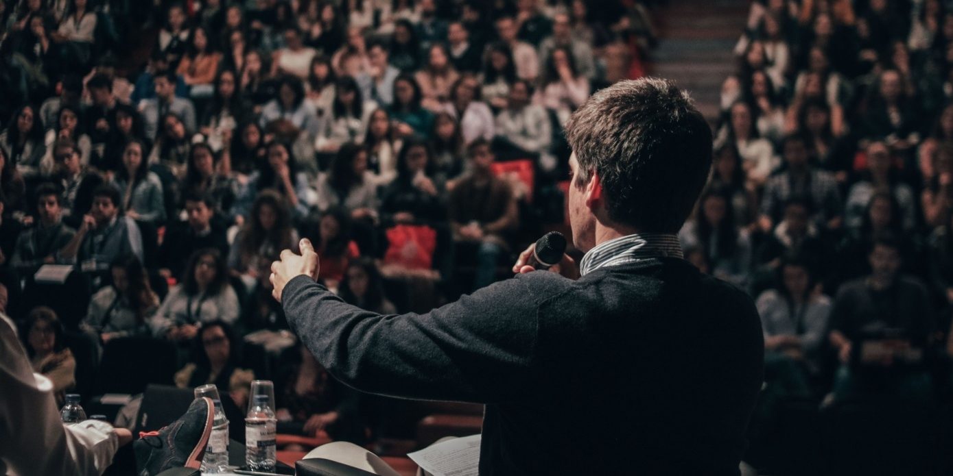 Man speaking in front of crowd