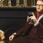 Samuel Dodson sat on a chair with a dog