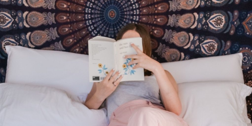 Woman reading a book on bed - quotes