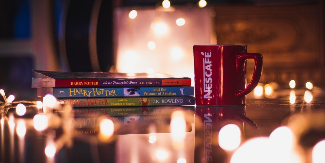 Harry Potter books next to a mug