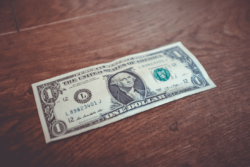 Dollar bill on a wooden surface
