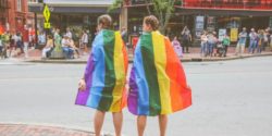 two women with LGBTQ+ flag