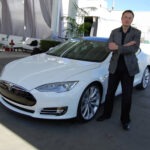 Elon Musk by a car / Image: Wikimedia Commons