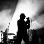 A black and white image of Echo and The Bunnymen on stage