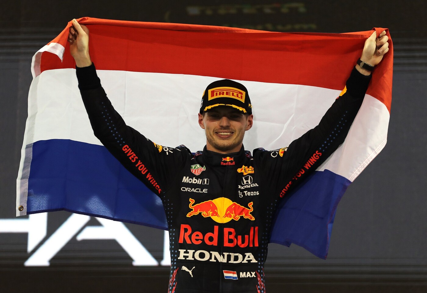 Max Verstappen holding aloft the Dutch flag