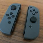 Two Nintendo Switch controllers on a piece of wood