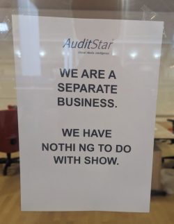 A sign reading "We are a separate business. We have nothing to do with show".