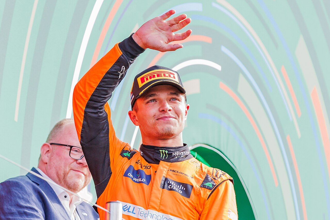 Lando Norris waves from the podium at the 2024 Dutch Grand Prix