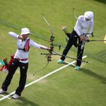 Two women holding bows and arrows