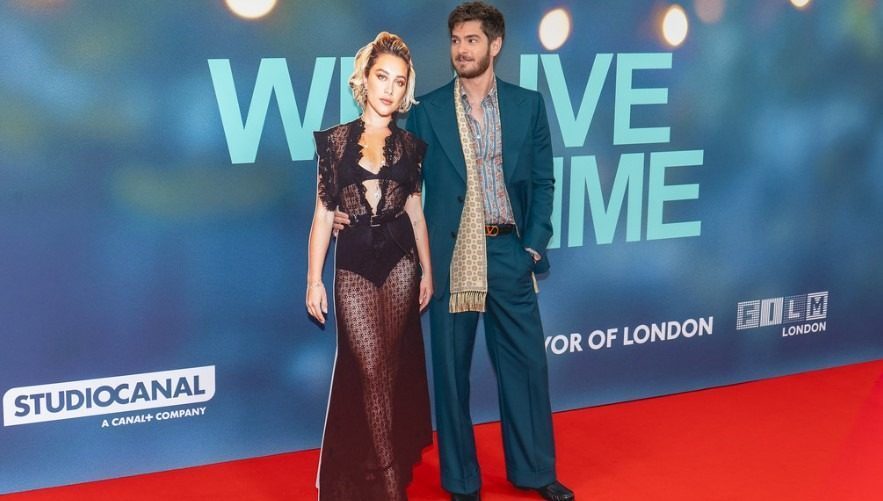 Andrew Garfield holds a cut-out of Florence Pugh at a film premier