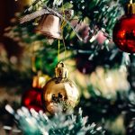 Bauble bells hang from a Christmas tree.