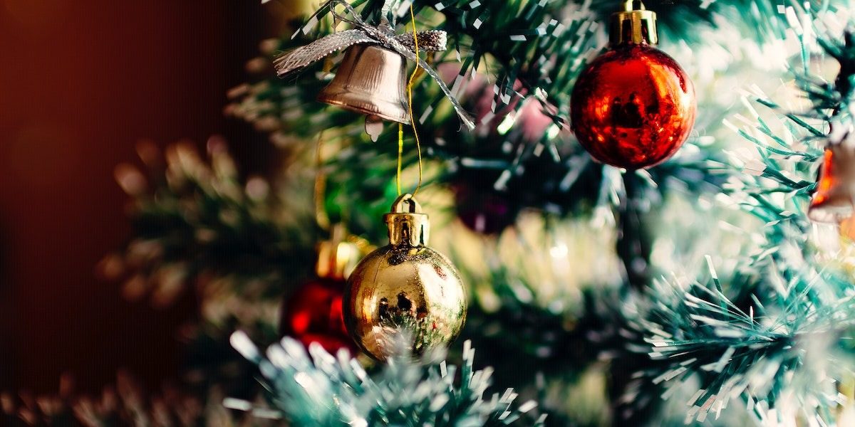 Bauble bells hang from a Christmas tree.