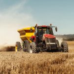 A tractor harvesting wheat.