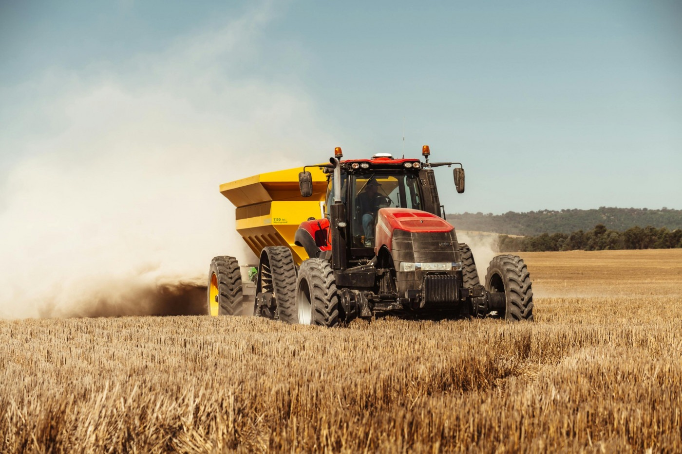 A tractor harvesting wheat.