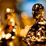 golden Oscar trophies in a line