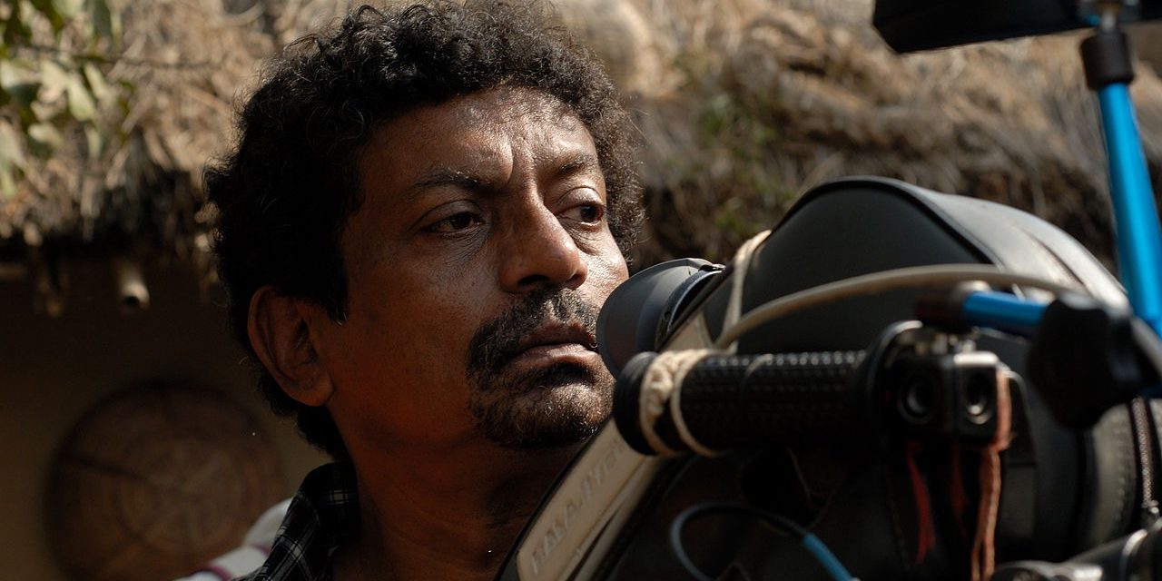 A focused male director in front of a camera