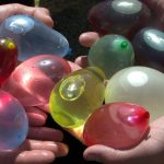 People holding water balloons