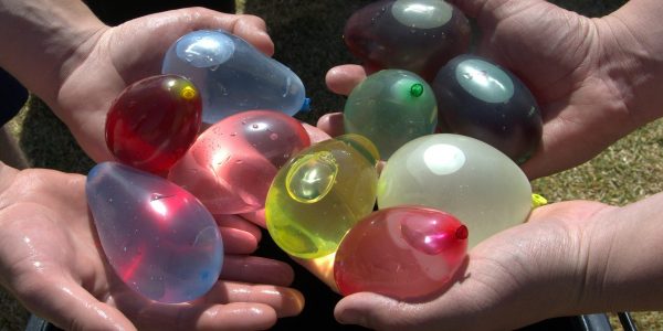 People holding water balloons
