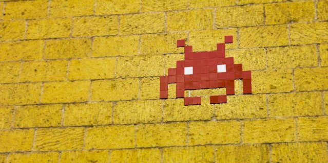 Yellow brick wall with red pixel avatar