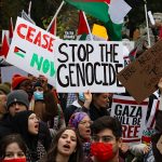 Protesters with banners and signs for Palestine