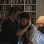 Robert Pattinson and Zenday in The Drama, sat on a bed, embracing
