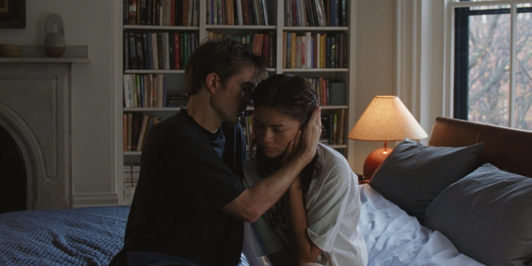 Robert Pattinson and Zenday in The Drama, sat on a bed, embracing