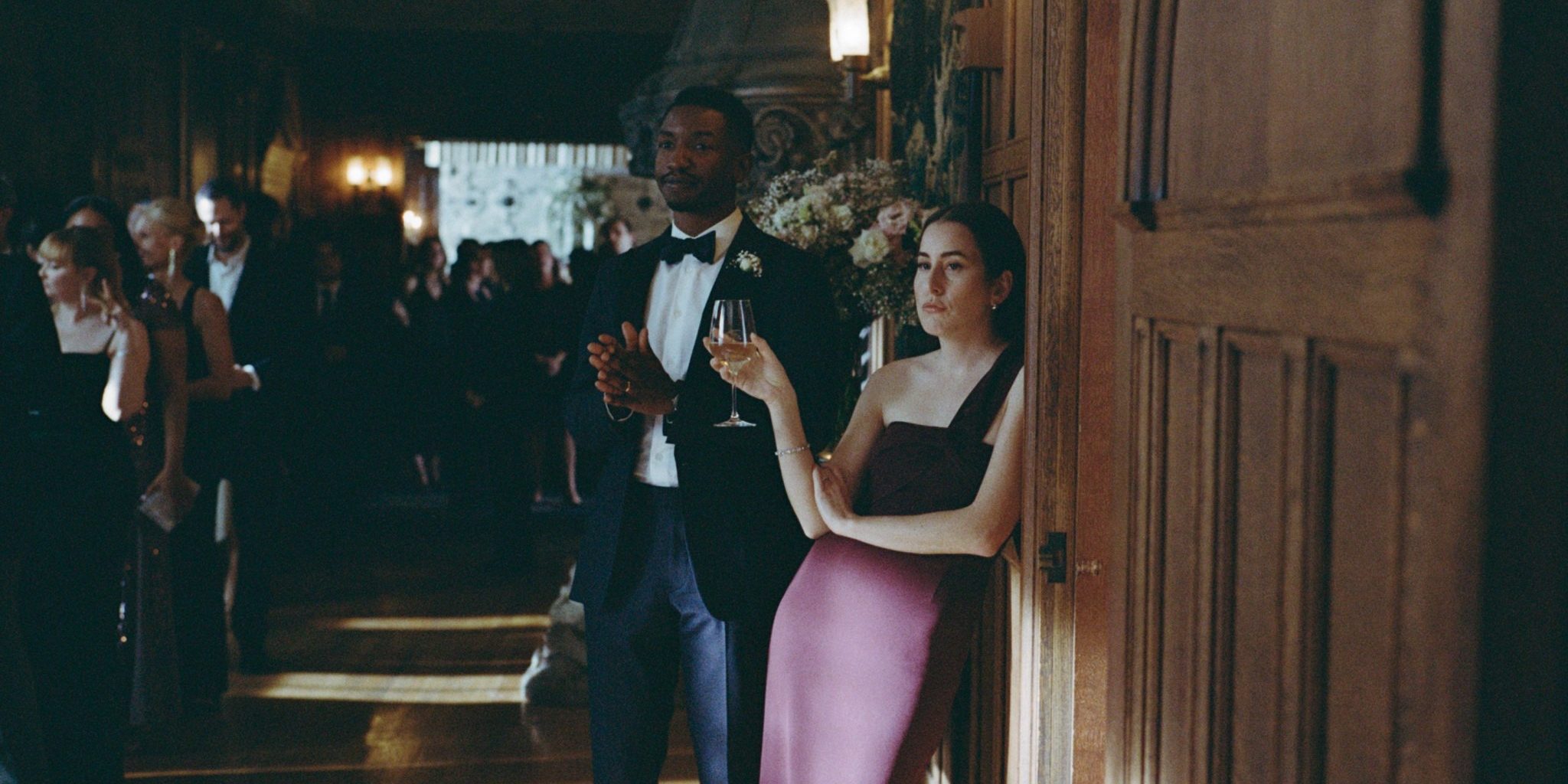 Mamoudou Athie and Alana Haim in The Drama, at a wedding
