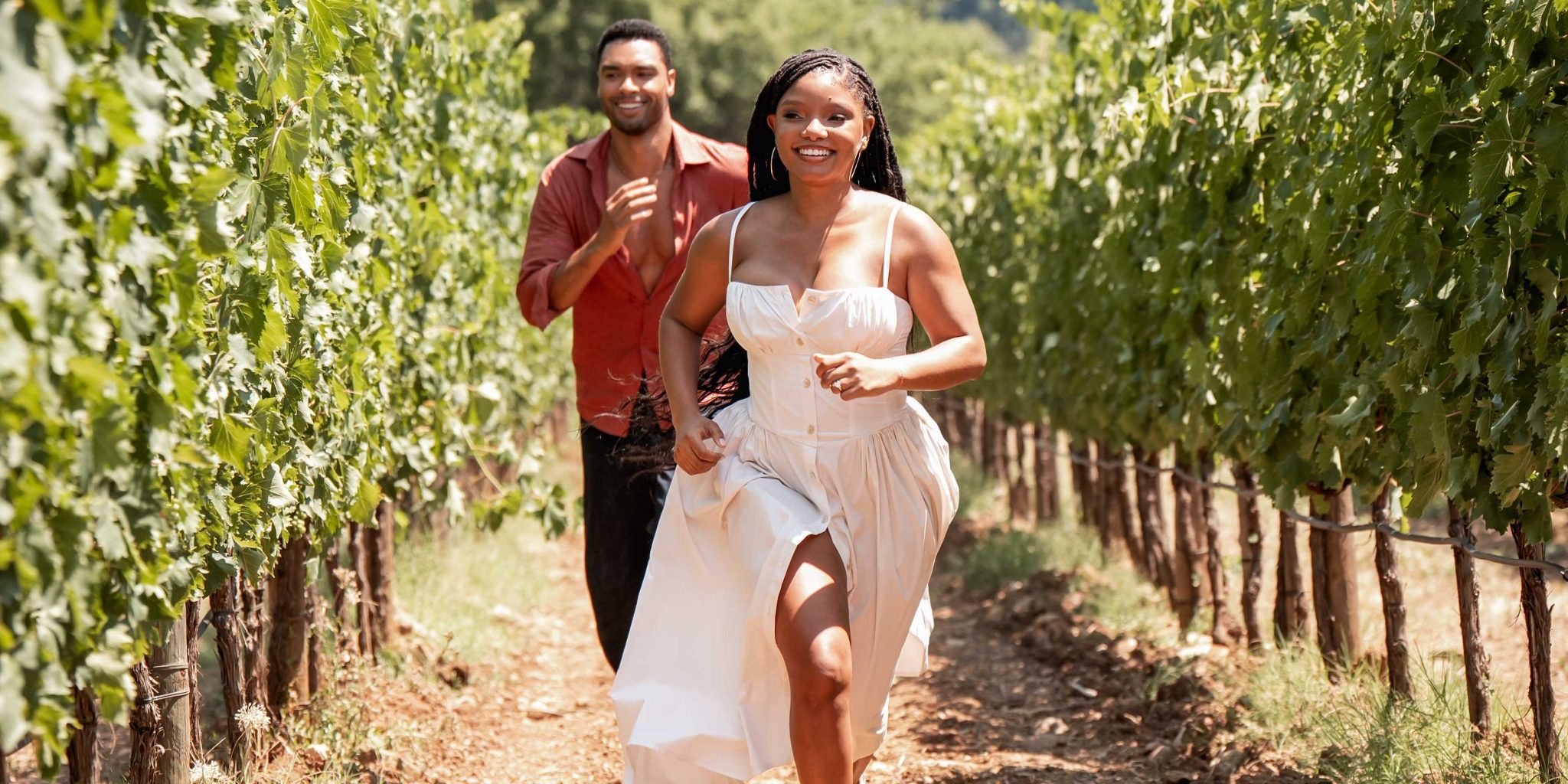 Halle Bailey and Rege Jean Page in You, Me & Tuscany, running together