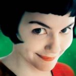 Film poster for Amélie featuring the main character smirking at the camera with a green background and yellow text