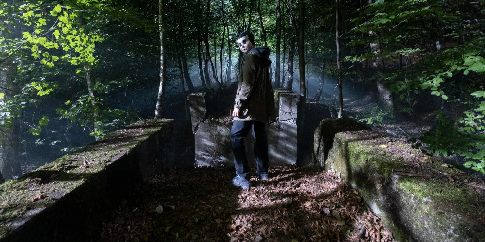 Masked figure in forest
