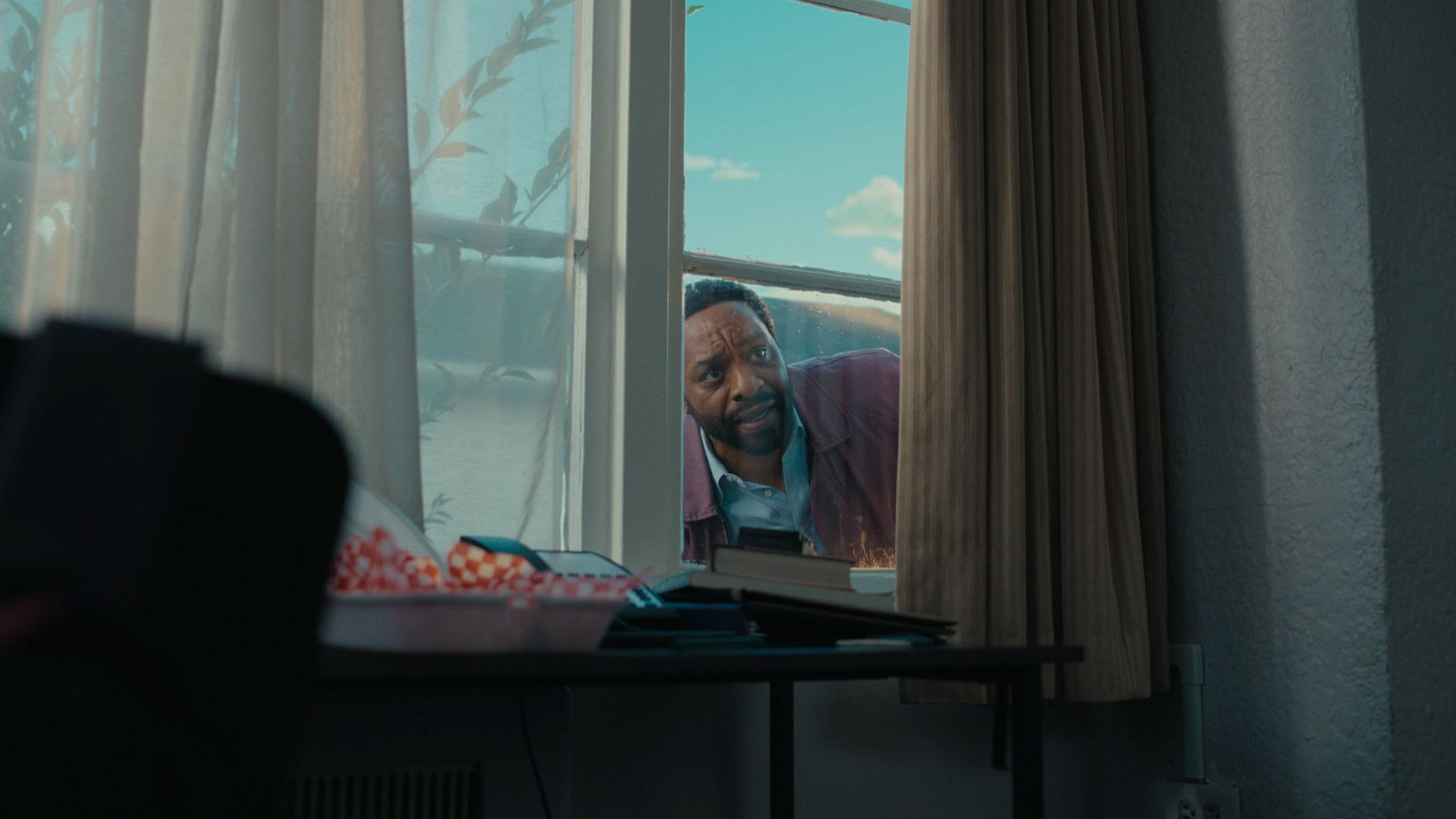 Man looking through window